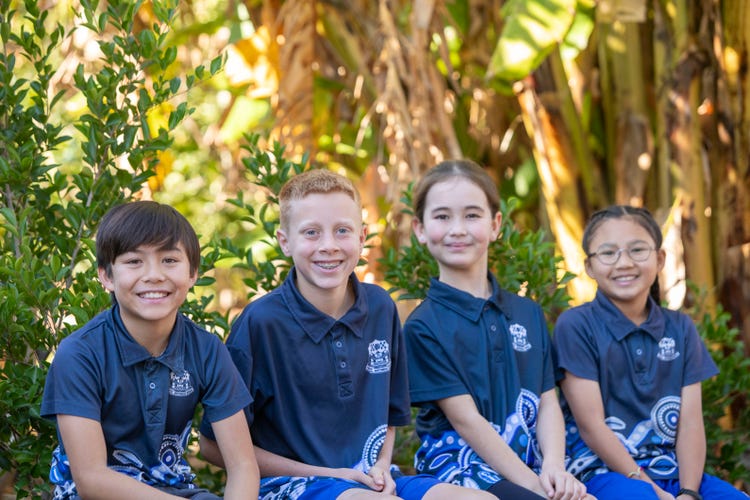 Students sitting near gardens