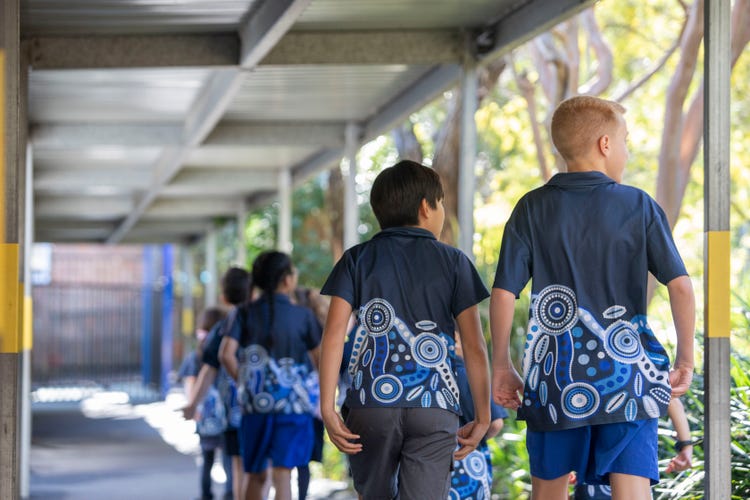 Student walking under sheltered path